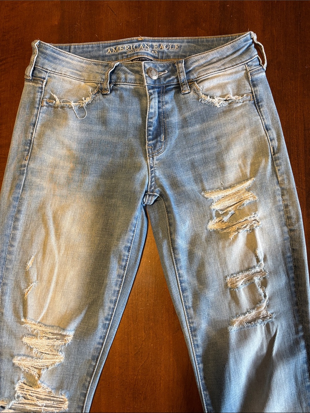 AMERICAN EAGLE OUTFITTERS- Light Blue Distressed Super Stretch Skinny Jeggings